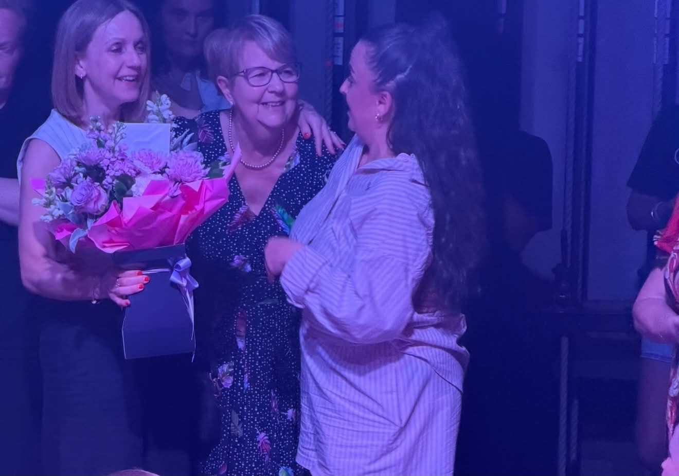 JA Performing Arts teacher receiving flowers on stage