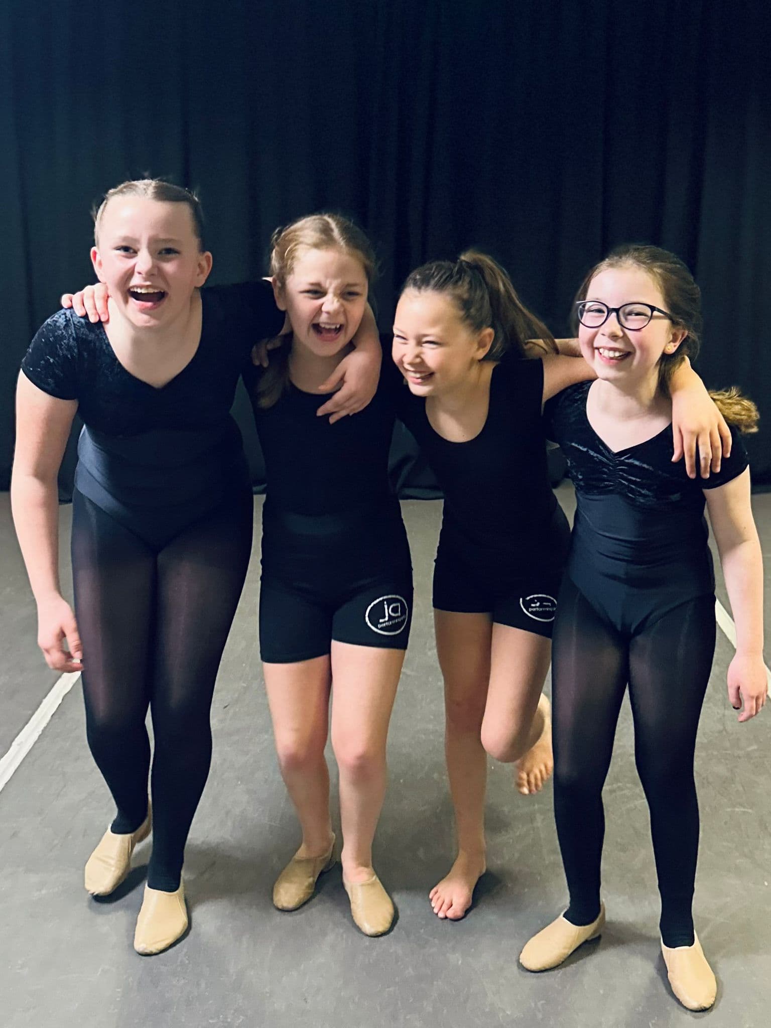 JA Performing Arts dancers laughing together in class